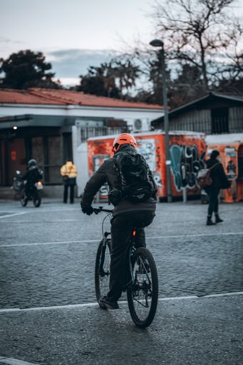 A guy riding a bike in the city of Athens in Greece