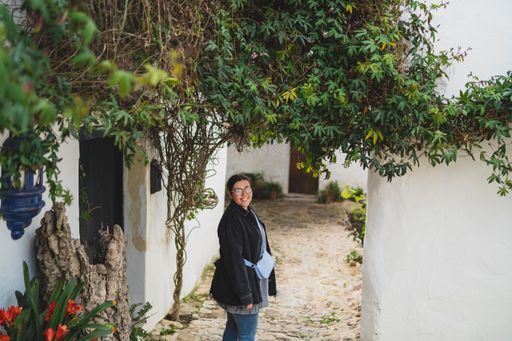 A view of a beautiful woman traveling in the streets of a small, cute town in Spain