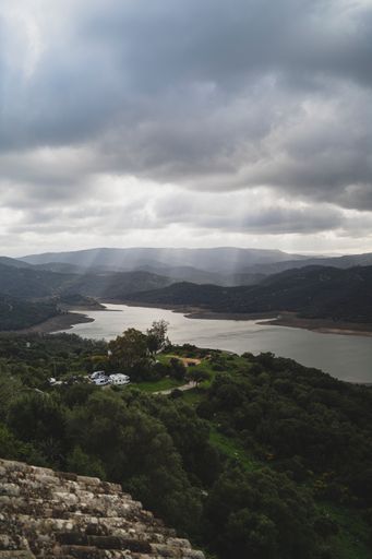 A beautiful view of the river among mountains under the sun rays