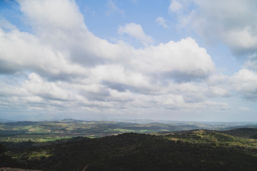 A beautiful view of the mountains under the cloudy sky on a sunny sky