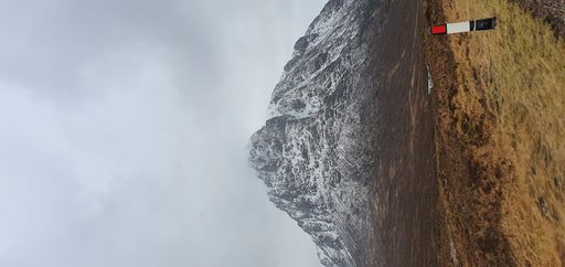 A vertical shot of a snowcapped mountain in the Scottish Highlands
