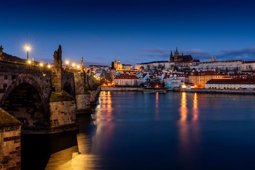 A beautiful shot of sunrise over Vltava River near Charles Bridge and the Old Town of Prague