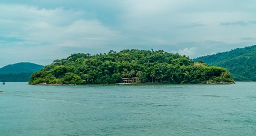 A tropical island with green trees off the coast of Paraty, Rio de Janeiro, Brazil