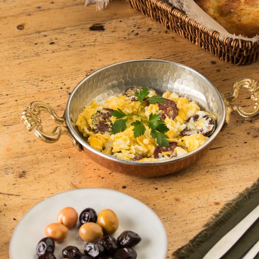 A bowl of omelet made from beaten eggs and served on a dining table