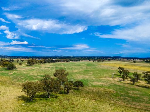 An aerial view of fields and valleys at Wellington Vale, Australia