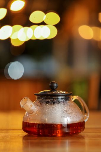 A vertical shot of hot tea in a teapot