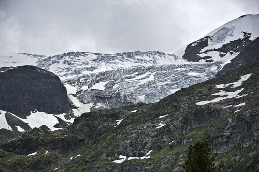 A mesmerizing scenery of the beautiful snow-capped mountains under a cloudy sky