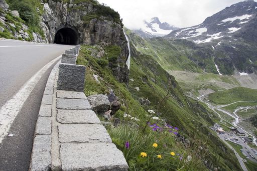 A mesmerizing scenery of the beautiful road among the mountains under a cloudy sky