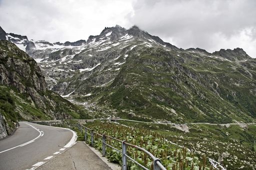 A mesmerizing scenery of the beautiful road among the mountains under a cloudy sky
