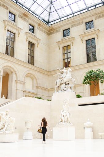 A shot of a girl in the Louvre Museum in Paris, France