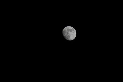 A grayscale shot of a moon isolated on black background