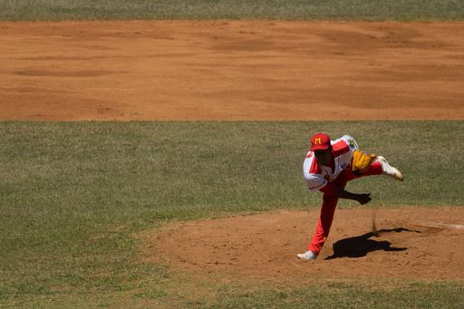 A shot of a baseball pitcher right after throwing the ball at a game between the Cocodrilos de Matanzas and the Alazanes de Granma