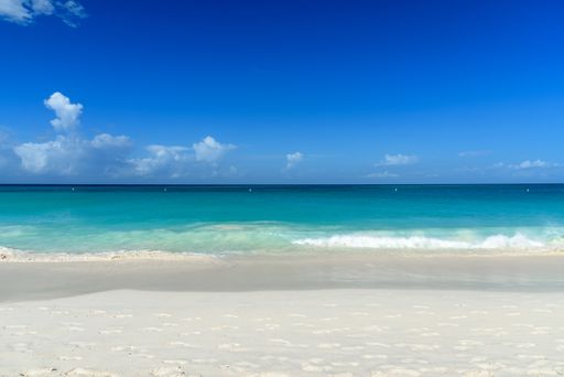 A horizontal shot of the mesmerizing view of the beach and sea during daylight -perfect for wallpaper