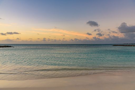 A horizontal shot of the mesmerizing view of the beach and sea at sunset -perfect for wallpaper