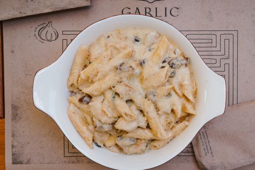 A high angel shot of delicious macaroni and cheese on a white plate