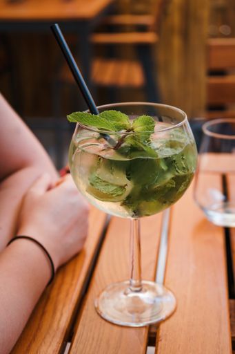 A vertical shot of a fresh mojito cocktail on wooden table