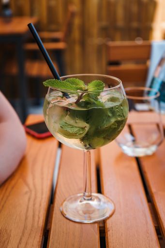 A vertical shot of a fresh mojito cocktail on wooden table