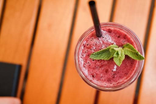 A closeup shot of berry smoothie on wooden table