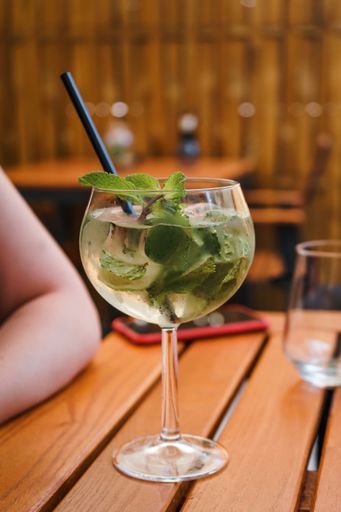 A vertical shot of a fresh mojito cocktail on wooden table