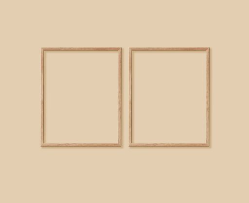 A closeup of two identical size frames on a light wall background