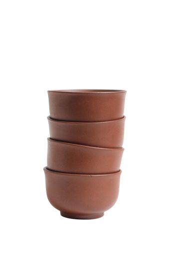 A vertical closeup of vintage Asian teacups isolated on white background.
