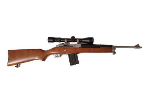 A closeup of a vintage semi-automatic rifle with scope and magazine isolated on white background.