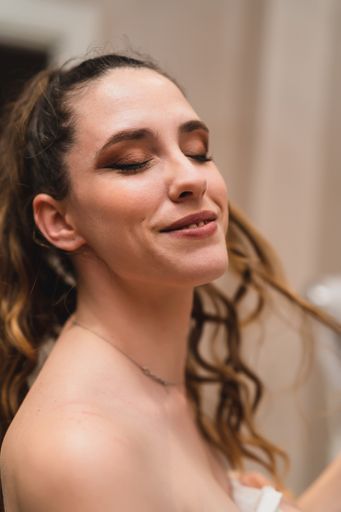 A close-up shot of the face of a young Caucasian woman with eyes closed.