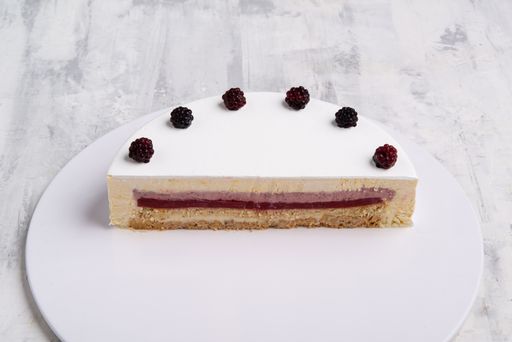 A closeup  shot of white-layered cake topped with fresh berries