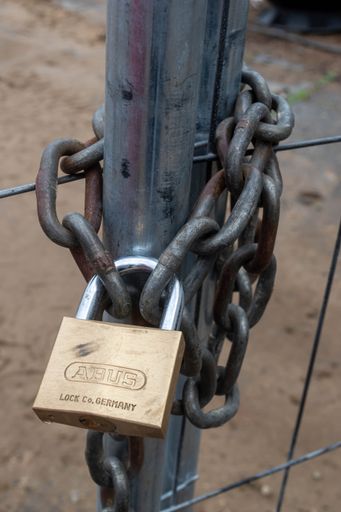 a vertical shot of a locked metal door.