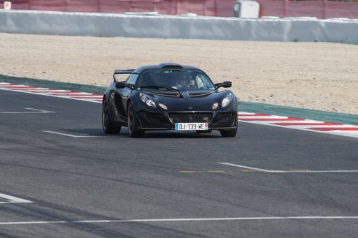 a closeup shot of sport cars on track in motion