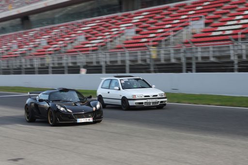 a closeup shot of sport cars on track in motion