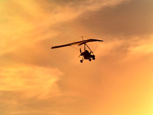 view of powered kite flying in a sunset