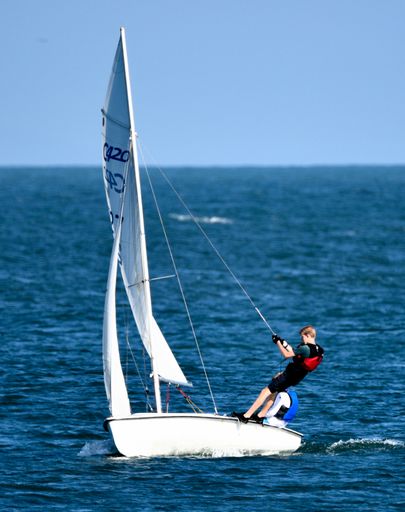 A vertical closeup shot of the small sailboat in the ocean of the Dana Point harbor, California, United States