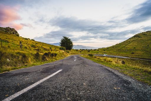 A long rural road under a sunset sky in Christchurch, New Zealand