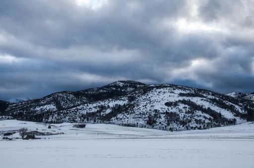 A snowy mountain range on a gloomy day