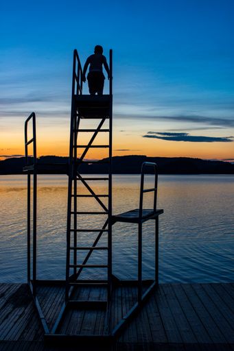 Diving board in Swedish Lake at sunset