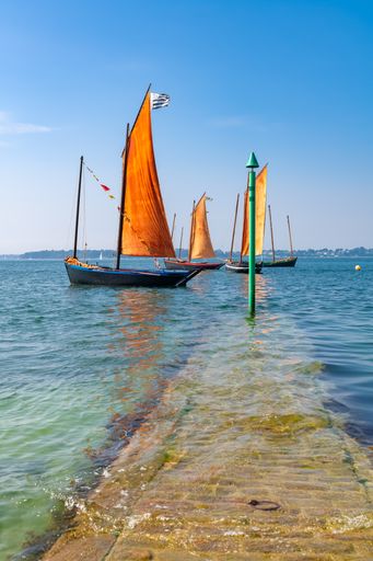 Old boat at the Ile-aux-Moines island, with red sails, traditional boat in the Morbihan gulf, Brittany