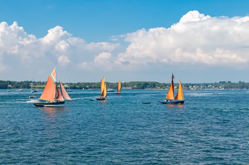 A sinagot, old boat at the Ile-aux-Moines island, with red sails, traditional boat in the Morbihan gulf, Brittany