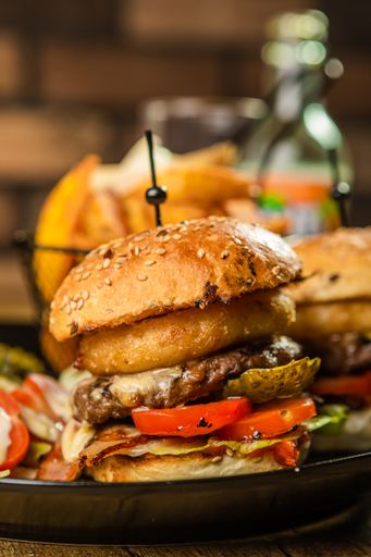 A soft focus of an appetizing burger served on a plate