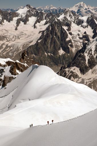A vertical shot of the magnificent mountain peaks covered with snow