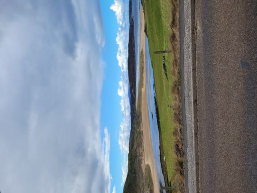 A beautiful view of Loch Humphrey as seen from the roadside against blue cloudy sky in west Dunbartonshire, Scotland