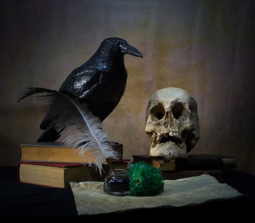 Books a human skull, a raven and a green carnation. English literature concept.