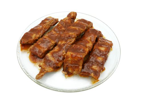 A serving of fried pork ribs on a white plate