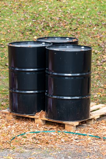 A vertical shot of black drums in a park