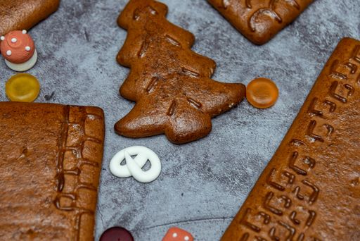 A closeup shot of a gingerbread cookie in a Christmas tree shape