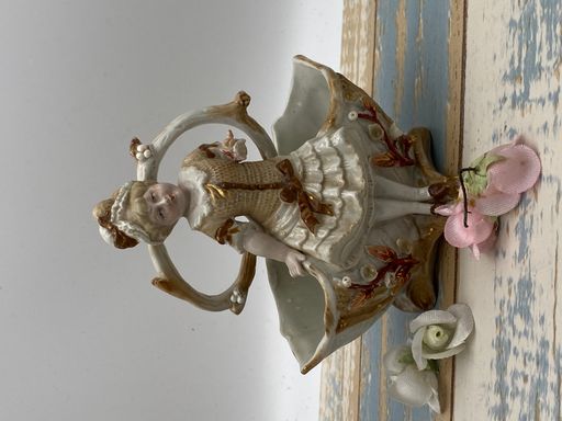 A vintage porcelain figurine of girl by the well,vertical shot