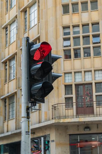 A vertical closeup shot of a traffic light with a red light in Pereira, Columbia