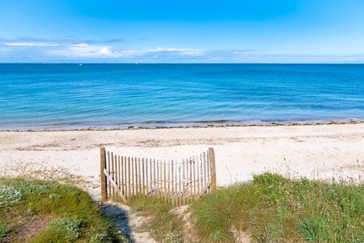 The Quiberon peninsula, in Brittany, beautiful beach with a wooden barrier
