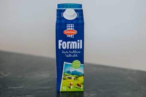 A closeup shot of Formil milk in a blue cardboard box placed on a table