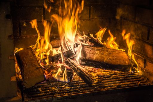 A closeup shot of burning fire in the fireplace in the darkness